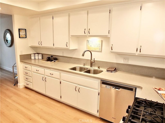 kitchen with sink, light hardwood / wood-style floors, white cabinets, and dishwasher