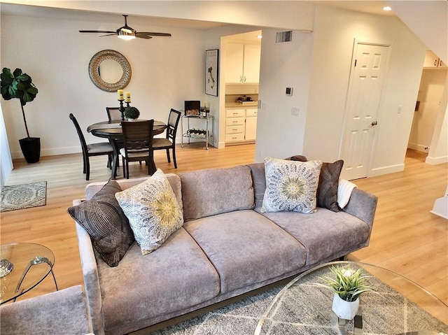 living room featuring ceiling fan and light wood-type flooring