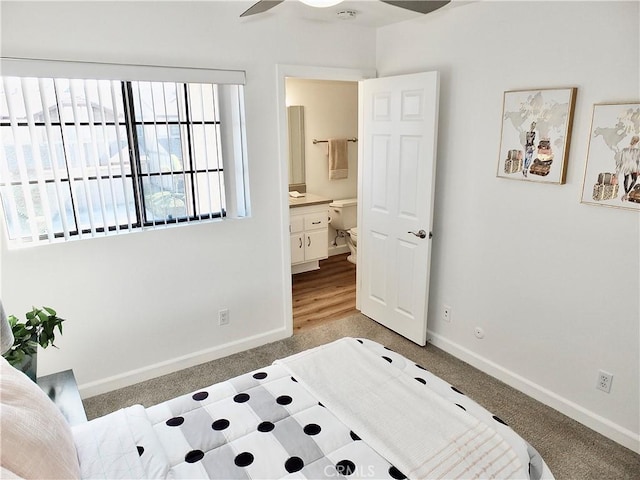 bedroom featuring connected bathroom and carpet