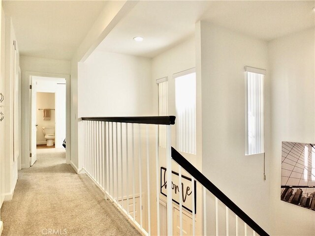 hallway with light colored carpet