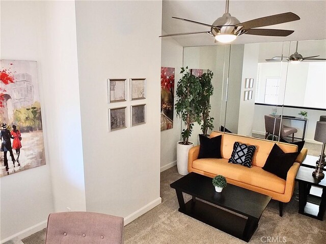 carpeted living room with ceiling fan