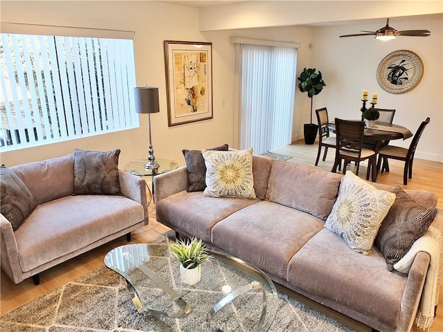 living room featuring ceiling fan and light wood-type flooring