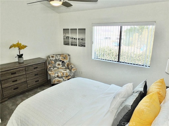 bedroom with ceiling fan and dark carpet