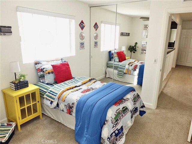 carpeted bedroom with a closet