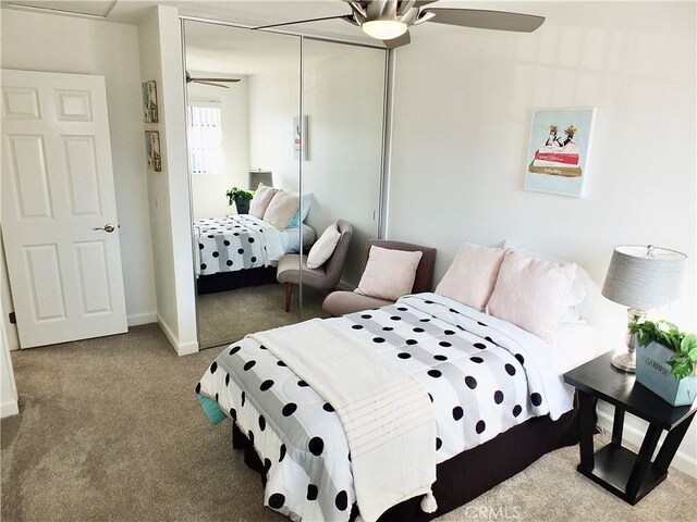 bedroom featuring ceiling fan, carpet flooring, and a closet