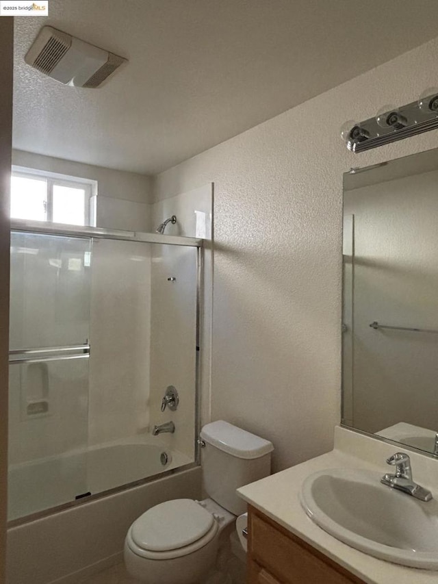 full bathroom featuring vanity, toilet, and combined bath / shower with glass door