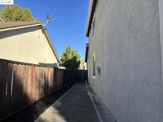 view of side of home with a patio area