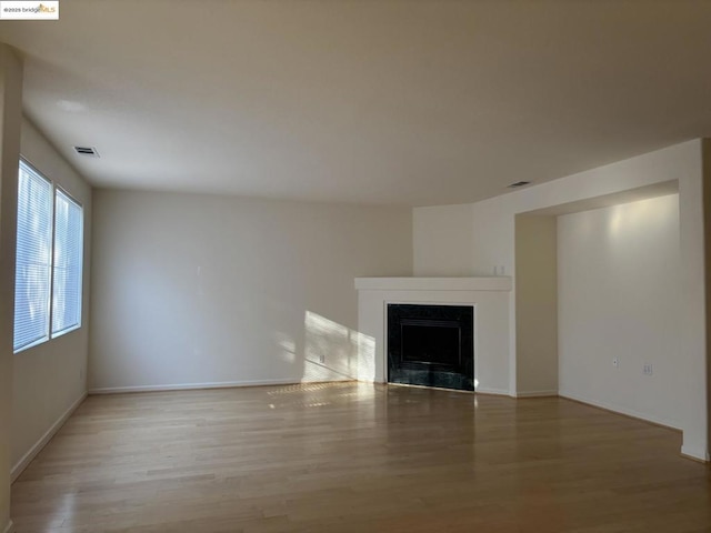 unfurnished living room with light hardwood / wood-style flooring