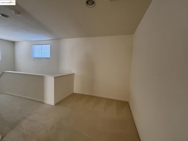 basement featuring light colored carpet