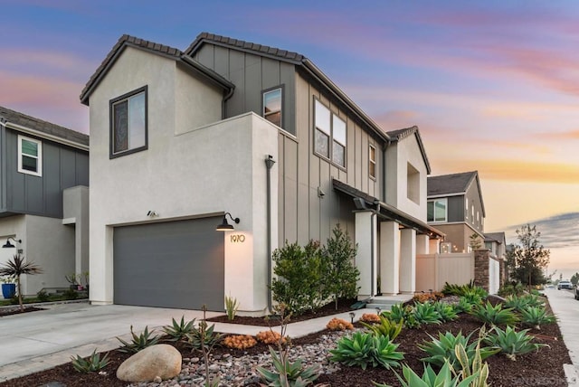 property exterior at dusk featuring a garage