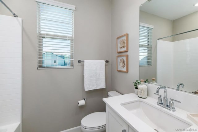 bathroom featuring vanity, plenty of natural light, and toilet