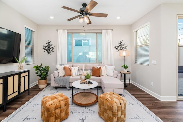 living room featuring dark hardwood / wood-style floors and ceiling fan