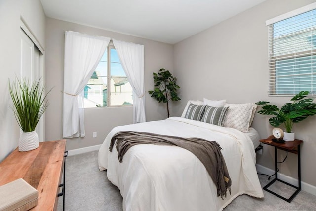 bedroom featuring light carpet and a closet