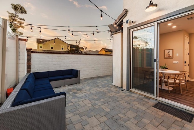 patio terrace at dusk with an outdoor living space