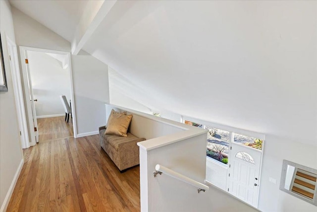 interior space with lofted ceiling and light hardwood / wood-style flooring