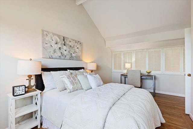 bedroom with beamed ceiling, hardwood / wood-style floors, and high vaulted ceiling