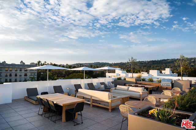 view of patio with outdoor lounge area and exterior kitchen