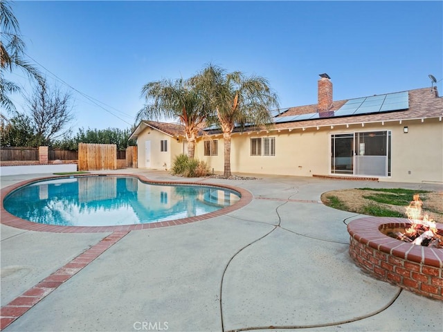 view of pool with an outdoor fire pit and a patio