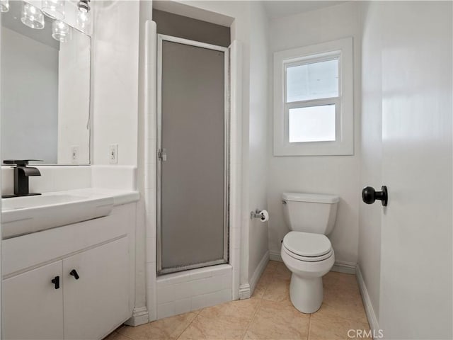 bathroom featuring tile patterned floors, vanity, toilet, and an enclosed shower