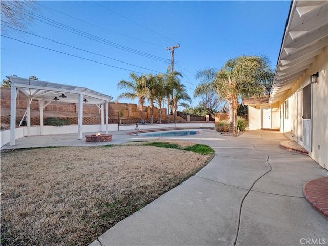 view of yard featuring an outdoor fire pit, a pergola, a fenced in pool, and a patio