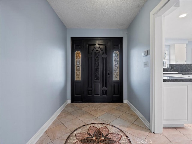 tiled entrance foyer with a textured ceiling