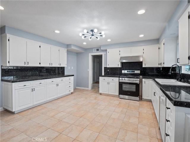 kitchen featuring white cabinetry, gas range, sink, and tasteful backsplash