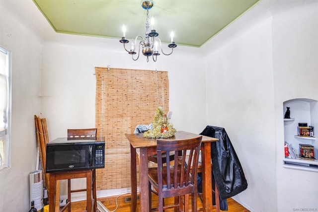 dining room with hardwood / wood-style flooring and a notable chandelier