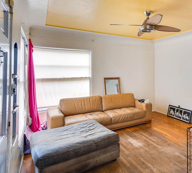 living room with wood-type flooring and ceiling fan