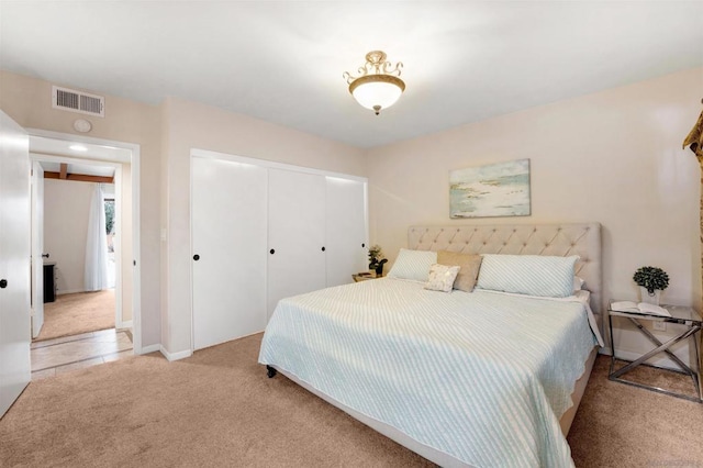 bedroom featuring light carpet and a closet