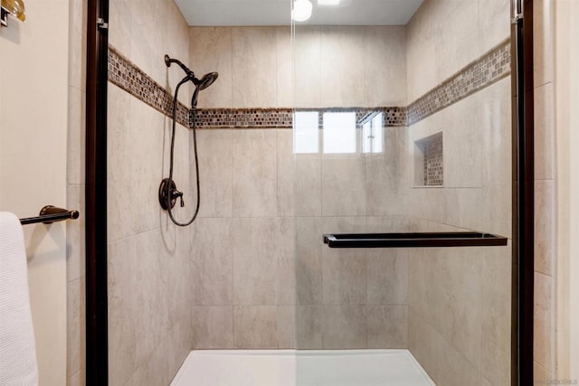 bathroom featuring a shower with shower door