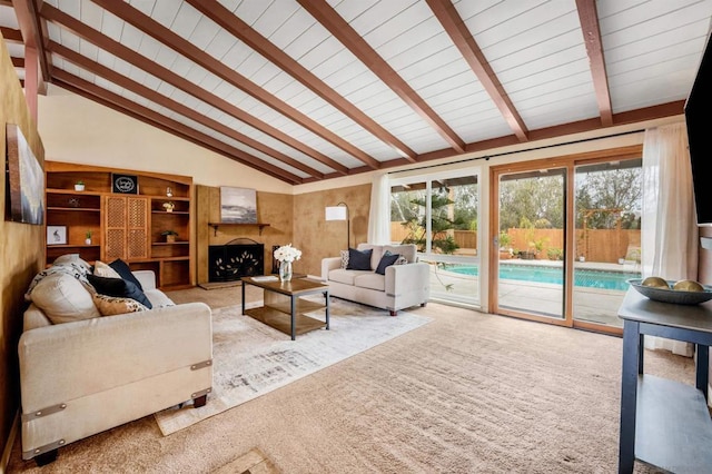 carpeted living room featuring lofted ceiling with beams, a premium fireplace, and a healthy amount of sunlight