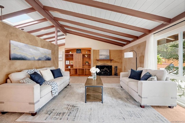 carpeted living room featuring lofted ceiling with beams and a large fireplace