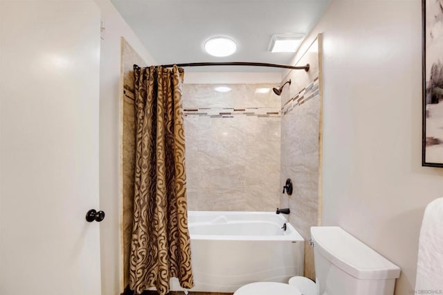 bathroom featuring shower / bath combination with curtain and toilet