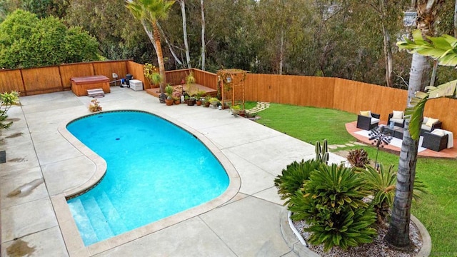 view of pool featuring outdoor lounge area, a yard, a hot tub, and a patio area