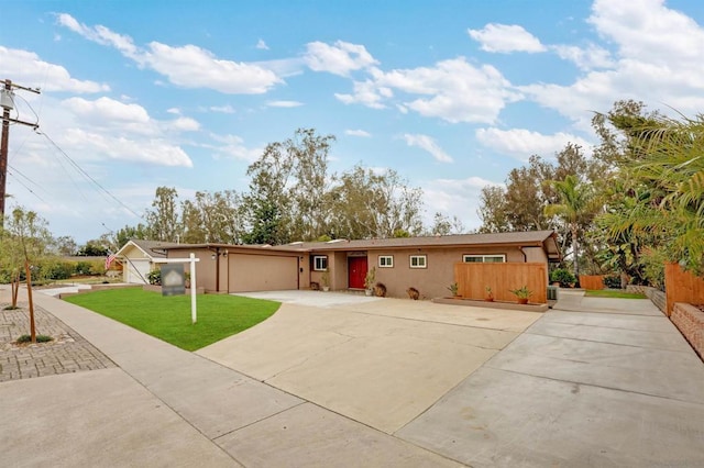 single story home featuring a garage and a front lawn