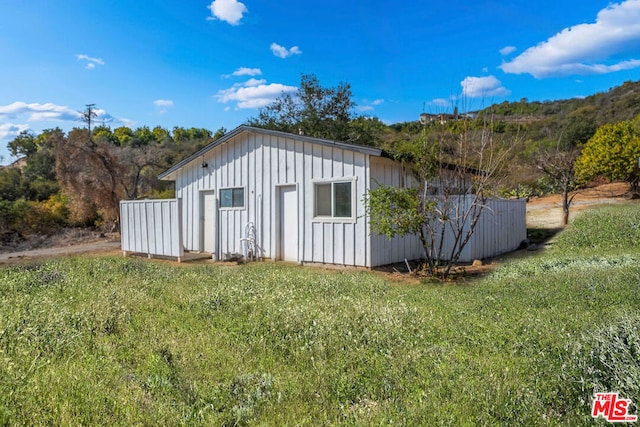 view of side of home featuring a yard