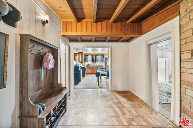 mudroom featuring wood ceiling and beam ceiling