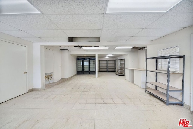 basement featuring a drop ceiling