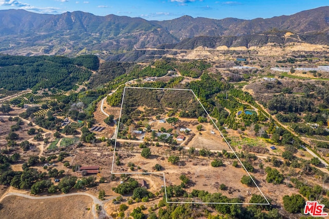 birds eye view of property with a mountain view