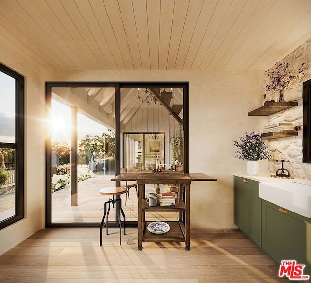 sunroom with sink and wooden ceiling