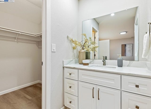 bathroom with vanity and hardwood / wood-style flooring