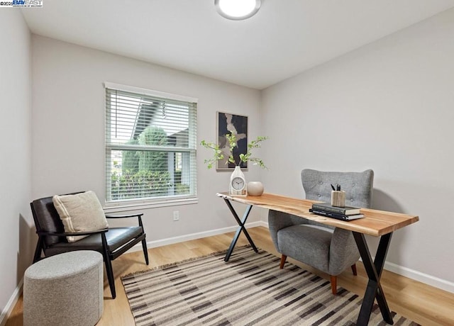 home office with light hardwood / wood-style floors