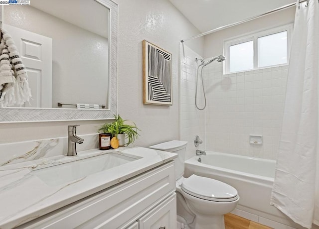 full bathroom with shower / bathtub combination with curtain, vanity, wood-type flooring, and toilet