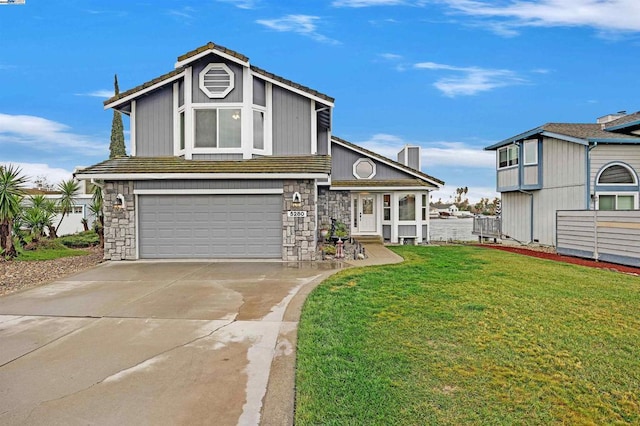 view of front of home with a garage and a front lawn