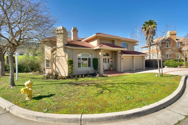 mediterranean / spanish home featuring a garage and a front lawn