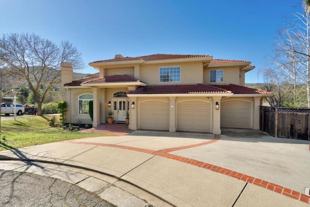 mediterranean / spanish home featuring a garage