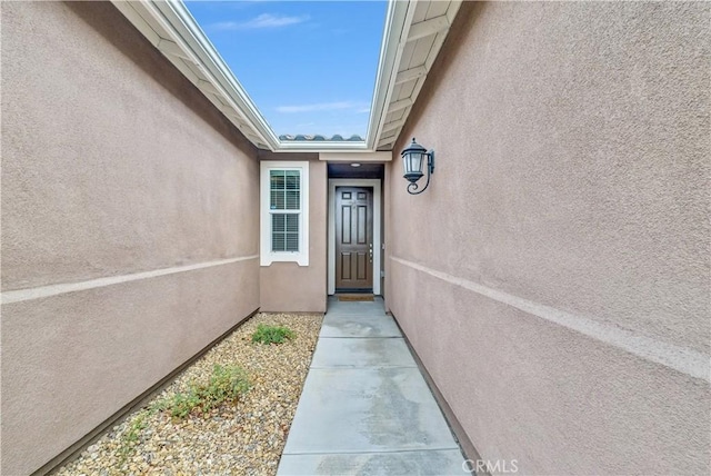 doorway to property with stucco siding