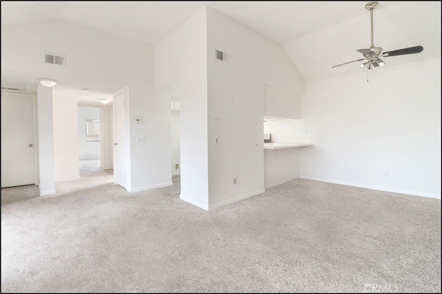 unfurnished living room featuring high vaulted ceiling, light colored carpet, and ceiling fan