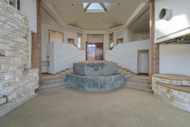 interior space with a skylight and concrete floors