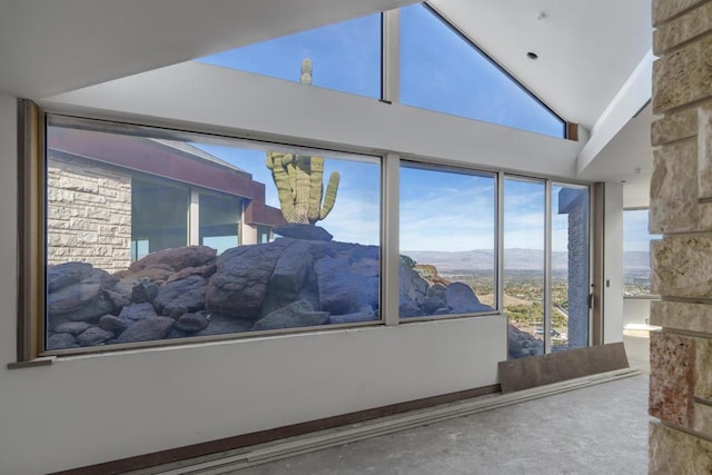 interior space featuring lofted ceiling and a mountain view